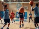 Engaged youth practicing basketball skills at Takeover Basketball Academy gym, showcasing dynamic training.