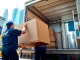 Trustworthy moving company nyc team carefully handling belongings in bustling cityscape.