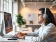 Showcase a user actively working with wps中文版 on a sleek laptop in a vibrant, modern office environment.