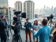 Showcasing video production edmonton team collaborating amidst the city skyline, highlighting creativity.