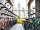 Organizing bikes in urban bike storage with sleek wall-mounted racks in a cityscape.