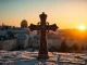 Admire a beautifully detailed Jerusalem crosses set against the historical backdrop of Jerusalem.